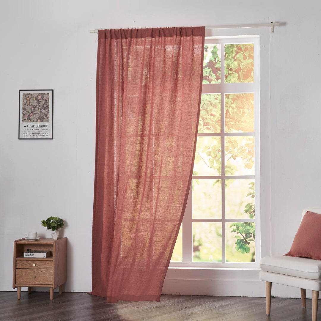 Rusk red linen drapery with rod pockets billowing over windows