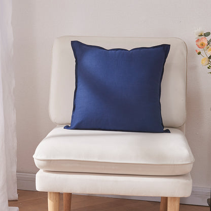 An indigo blue 100% linen edge embroidery cushion on an accent chair