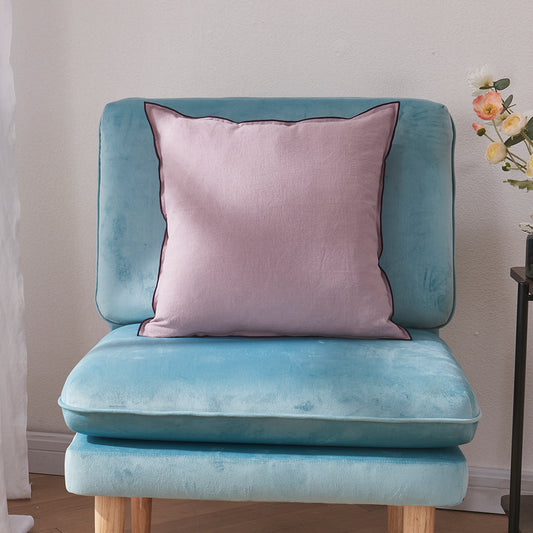 A lilac 100% linen edge embroidery cushion on an accent chair