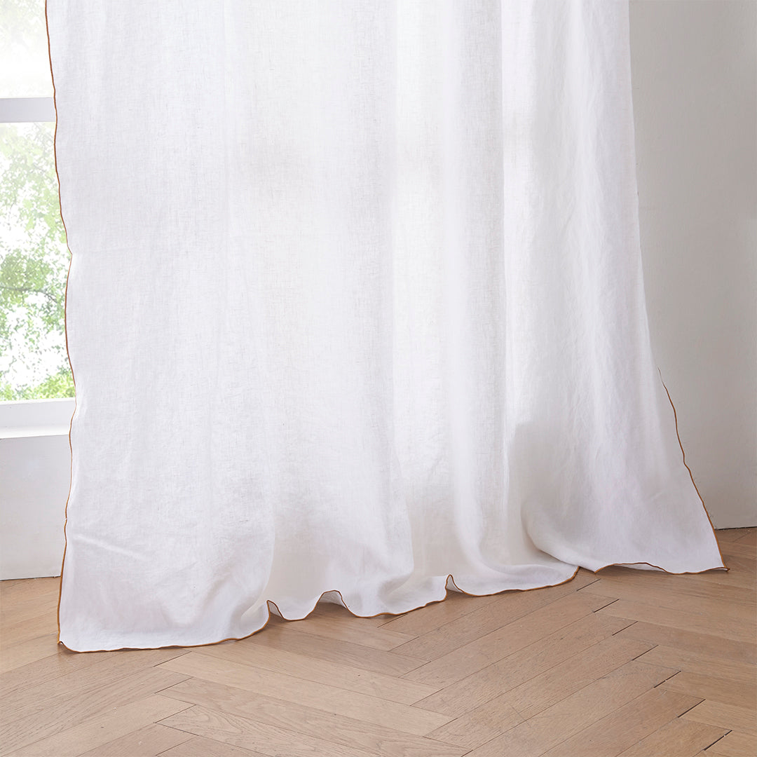 Hem of White Linen Curtain with Mustard Yellow Embroidered Edge on Window