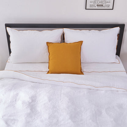 Breathable White Linen Duvet Cover with Mustard Yellow Embroidered Edge on Bed