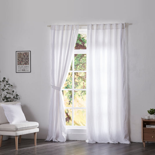 Optic white linen drapery with cotton lining hanging over windows