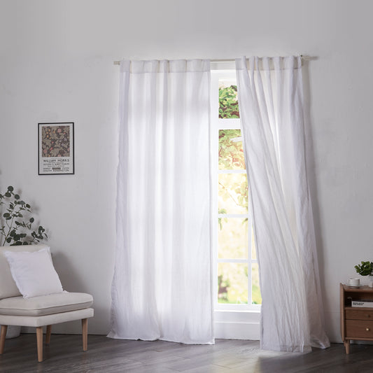 Optic white linen drapery with cotton lining billowing over windows