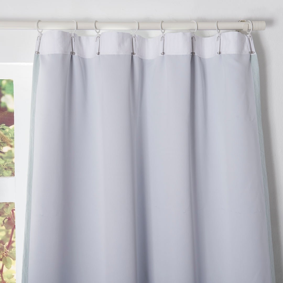 Back details of pale blue curtains with blackout lining