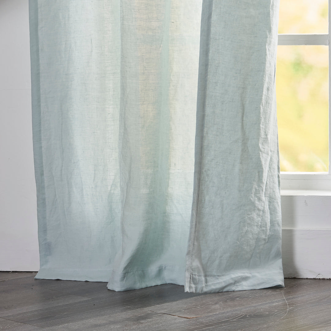 Close-up of 100% linen pale blue curtain hems