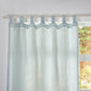 Close-up of the top of pale blue linen drapery