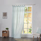Pale blue linen drapery with tab tops billowing over windows