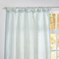 Close-up of the top of pale blue linen drapery