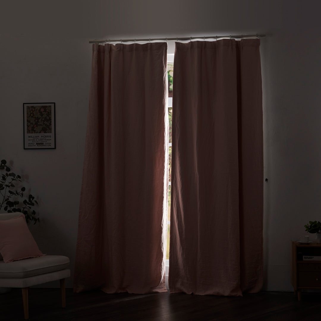 Peach linen drapery with blackout lining drawn closed over windows