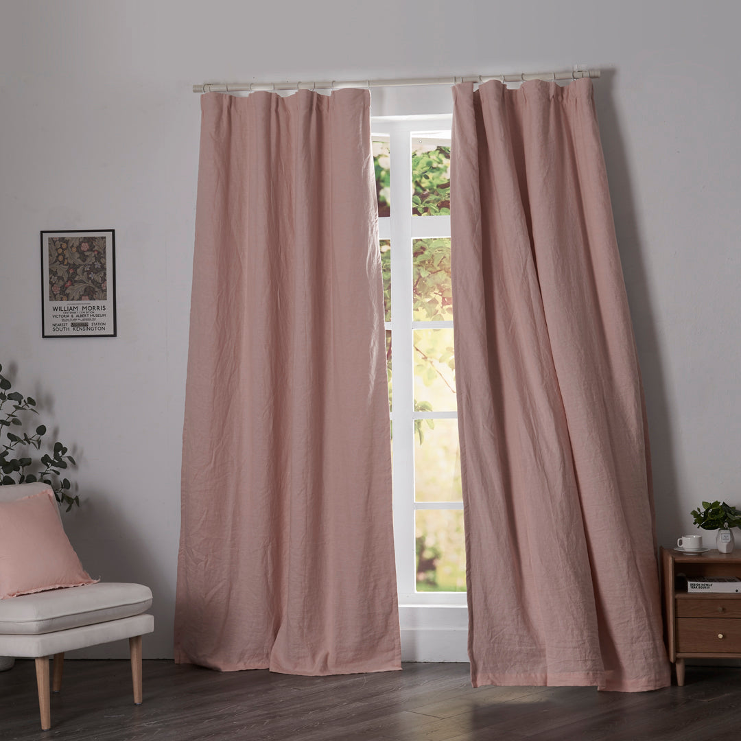 Peach linen drapery with blackout lining billowing over windows