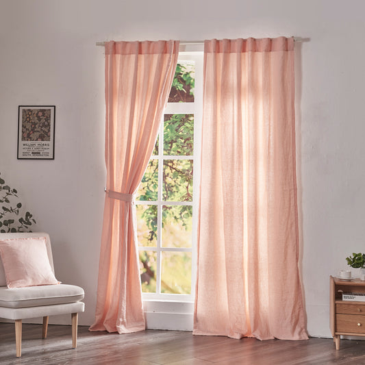 Peach linen drapery with cotton lining hanging over windows