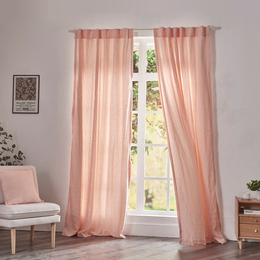 Peach linen drapery with cotton lining billowing over windows