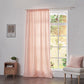 Peach linen drapery with rod pockets hanging over windows