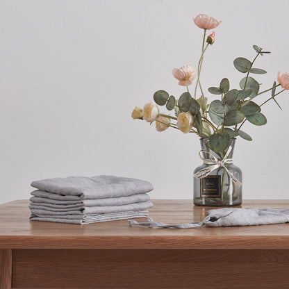 Stack of 100% Linen Napkins in Alloy Grey with Flowers on Table