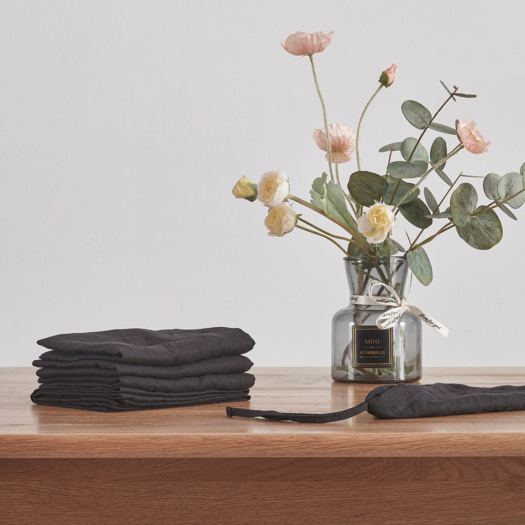 Stack of Black Linen Placemats on Table