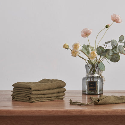 Stack of Linen Olive Green Placemats on Table
