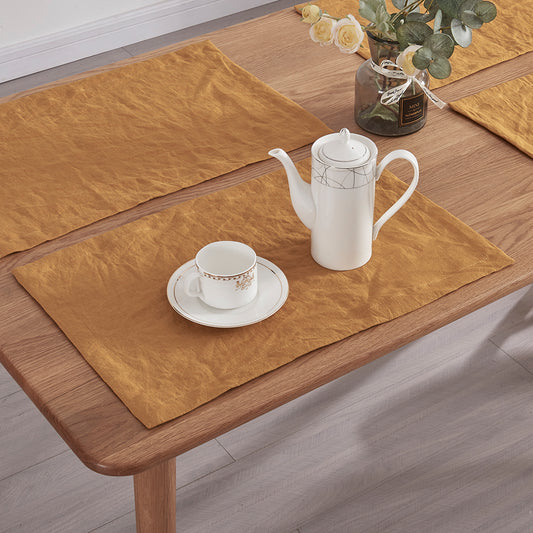 A detailed close-up of 100% linen mustard placemats with tea set