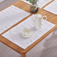 Close-up of optic white 100% linen placemats set on a wooden dining table with tea set