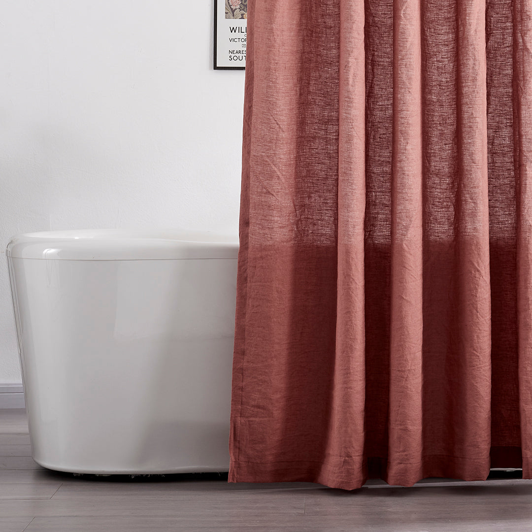 Close-up of 100% linen rust red shower curtain hanging over ceramic tub