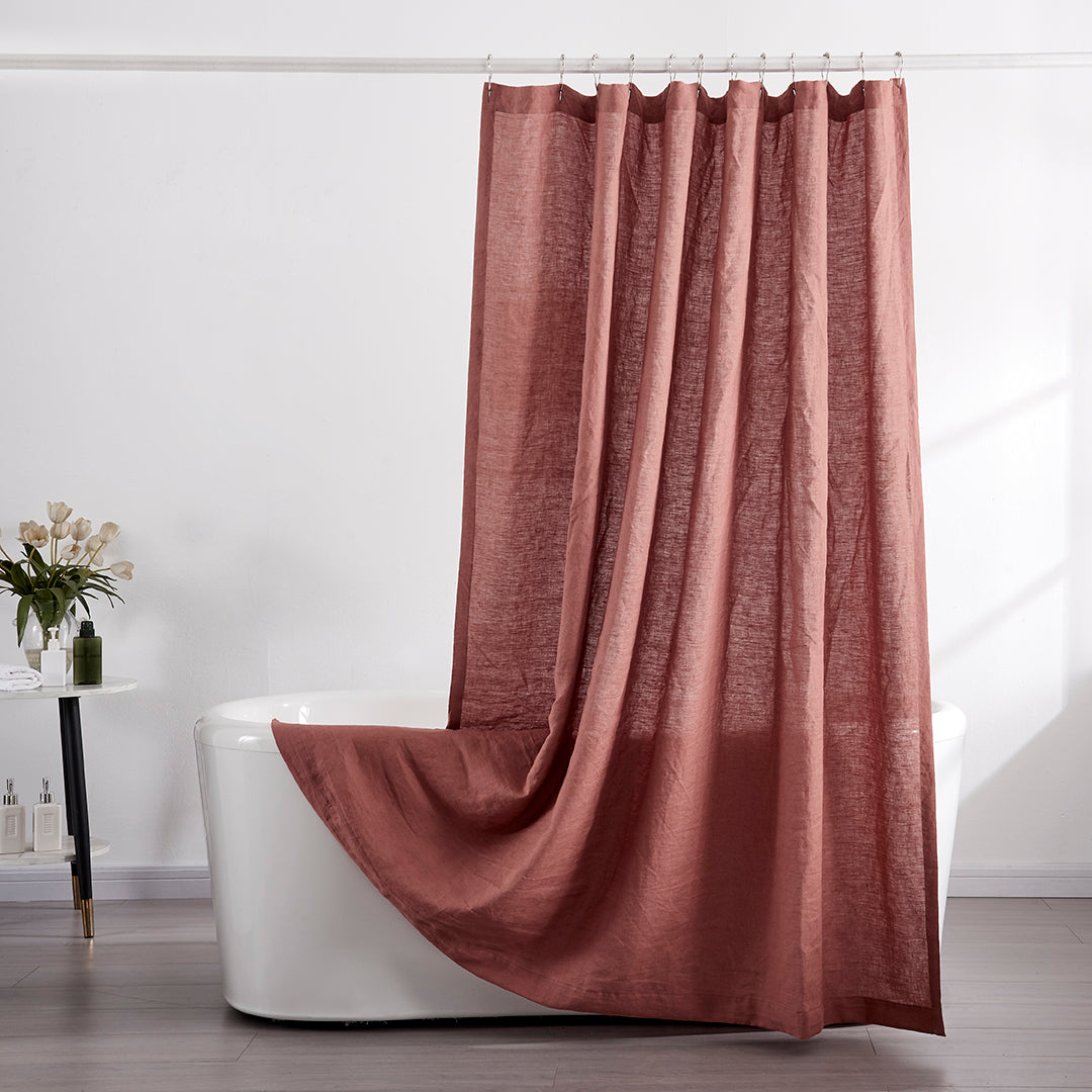 100% linen rust red shower curtain draped over ceramic tub