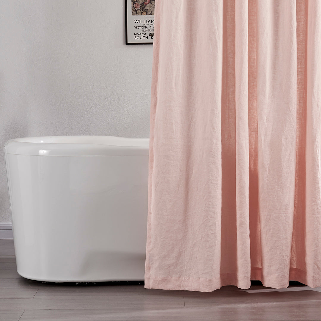 Close-up of 100% linen peach shower curtain hanging over ceramic tub