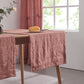 Close-up of rust red table runners made from 100% linen draped over a wooden table