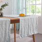 Close-up side angle detail of 100% linen pale blue table runners over wooden table