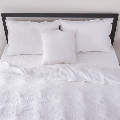 White Linen Duvet Cover with Embroidered Edge on Bed