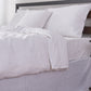 Close-up side detail of 100% linen duvet cover with white colored edge embroidery