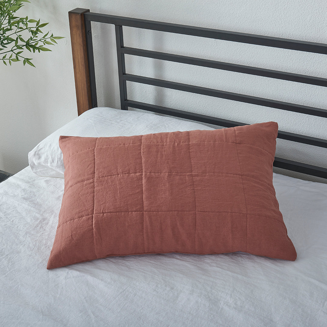 Rust Red Linen Quilted Pillow Sham on Bed